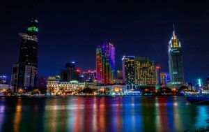 A modern cityscape of Ho Chi Minh City at night with glowing lights.