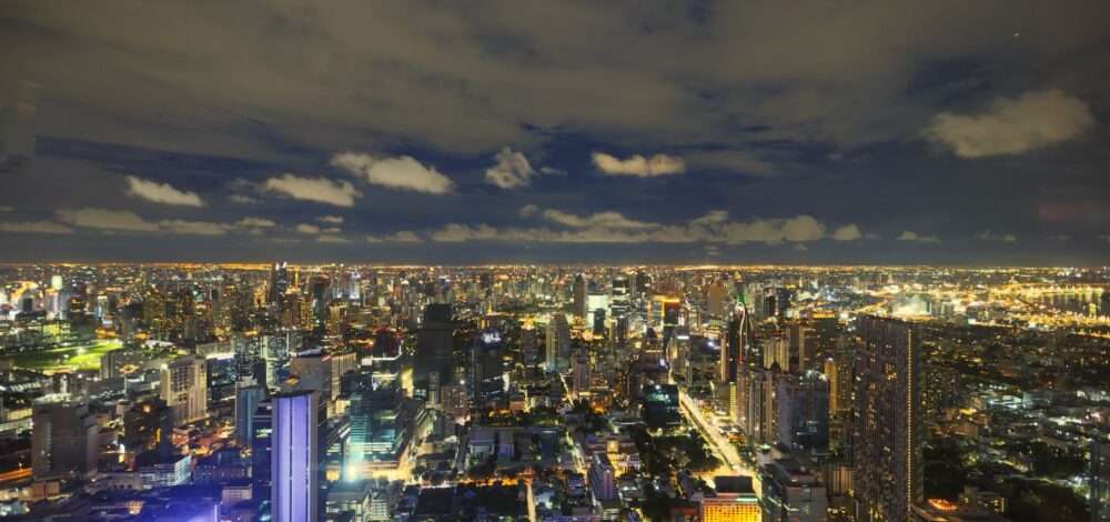 Modern casino resort silhouette against Bangkok skyline