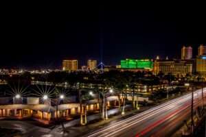 Aerial view of a bustling casino resort at night with bright lights