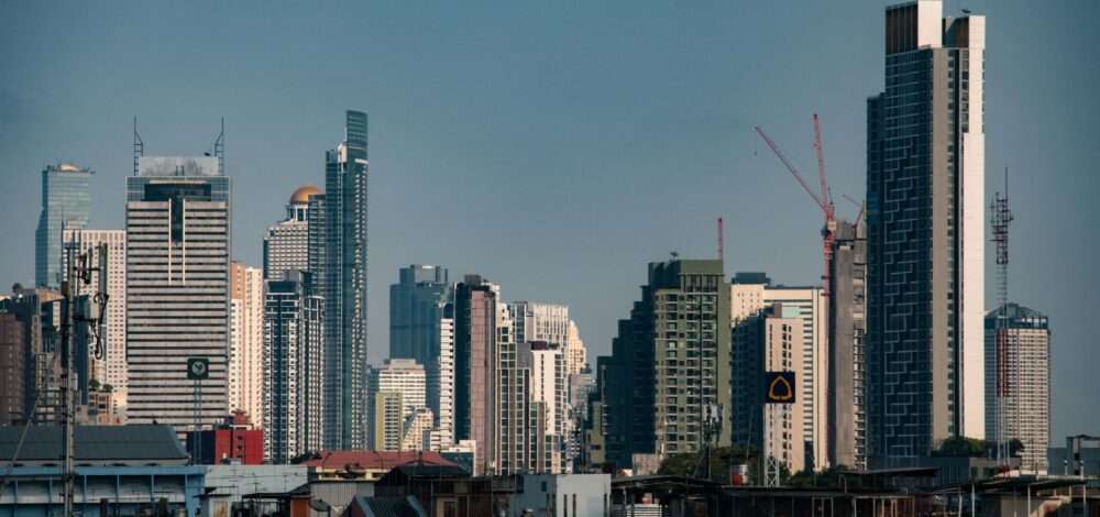 Aerial view of modern Bangkok city skyline with conceptual entertainment complex